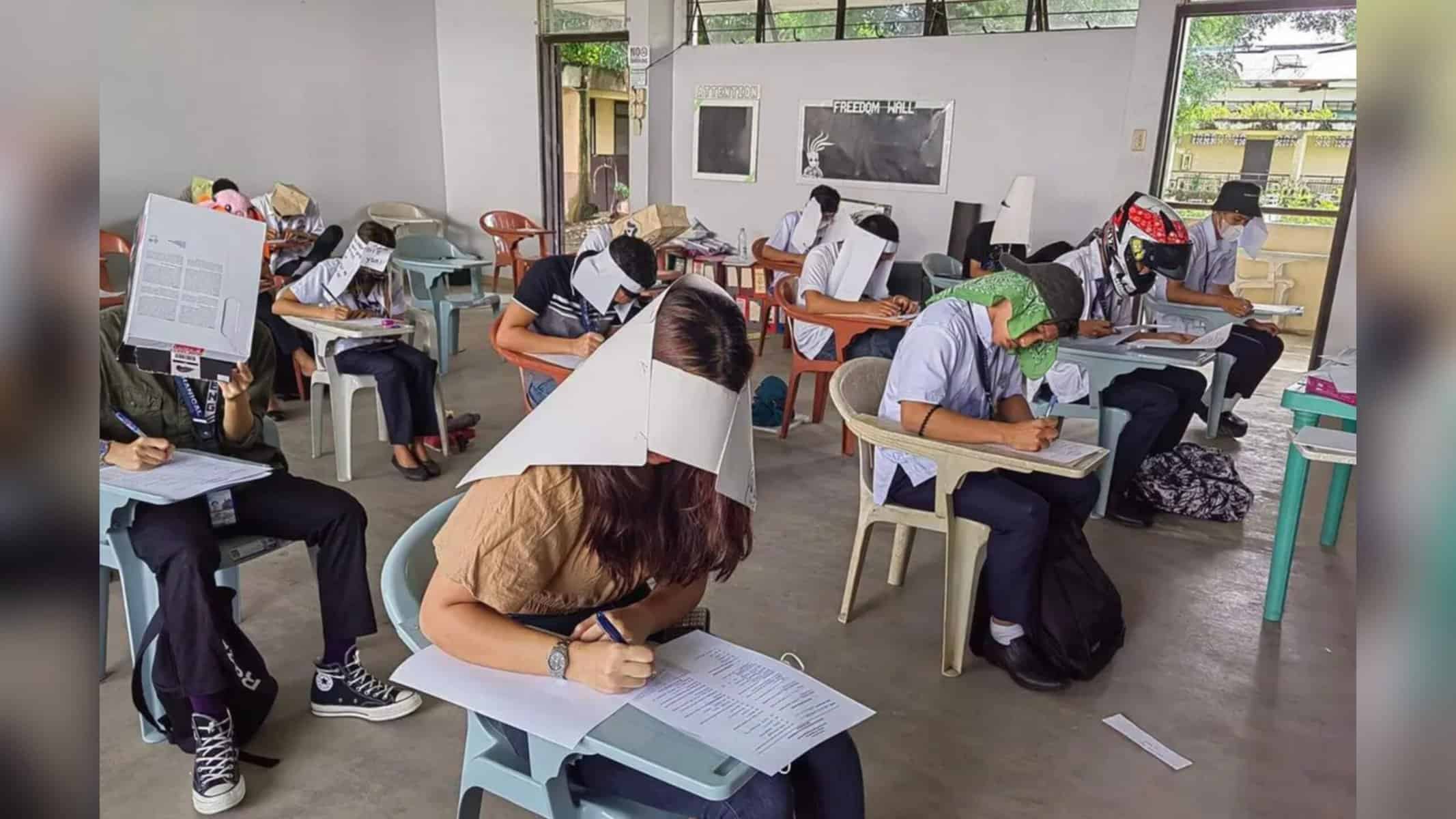 Picsart_22-10-24_15-46-09-501 Os alunos foram convidados a adotar chapéu para bloquear o campo de visão e evitar o contato seus colegas — Foto: Reprodução Redes sociais