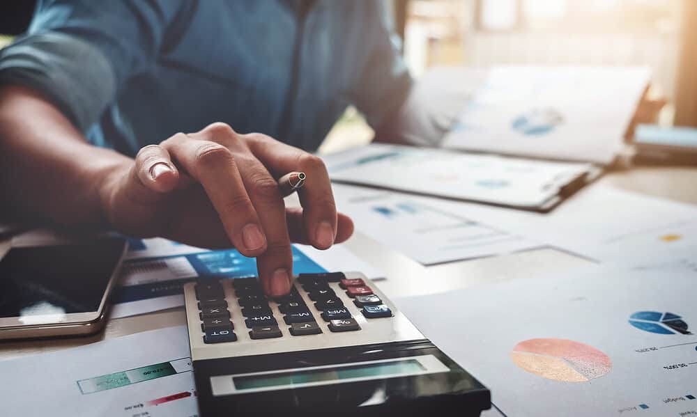 Business accounting concept, Business man using calculator with computer laptop, budget and loan paper in office. Business accounting concept, Business man using calculator with computer laptop, budget and loan paper in office.