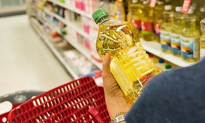 Shopping for cooking oil Caucasian housewife shopping for vegetable oil in a supermarket alley