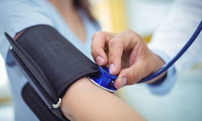Doctor checking female patient blood pressure in the hospital Doctor checking female patient blood pressure in the hospital