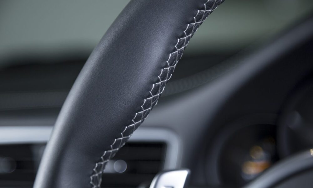 closeup-shot-black-car-s-modern-interior-wheel