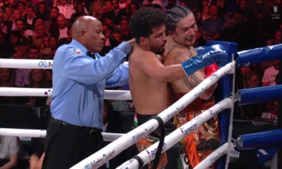 Whindersson Nunes ri enquanto é encurralado pelo boxeador indiano Neeraj Goyat • Reprodução/X @NetflixBrasil